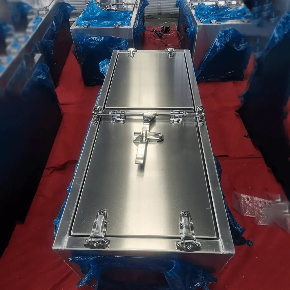 Top view of long low-profile aluminum truck tool box during factory inspection