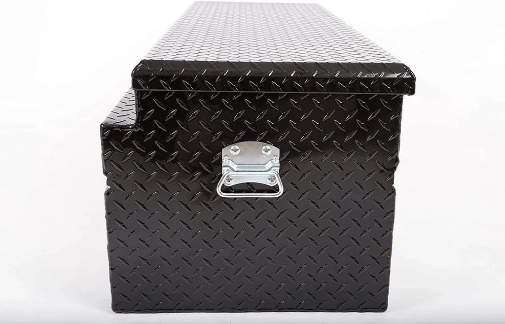Side profile of closed black aluminum truck tool box with checker plate surface and carry handle