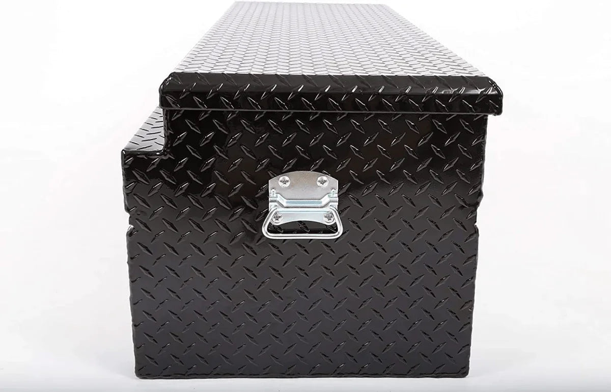 Side profile of closed black aluminum truck tool box with checker plate surface and carry handle