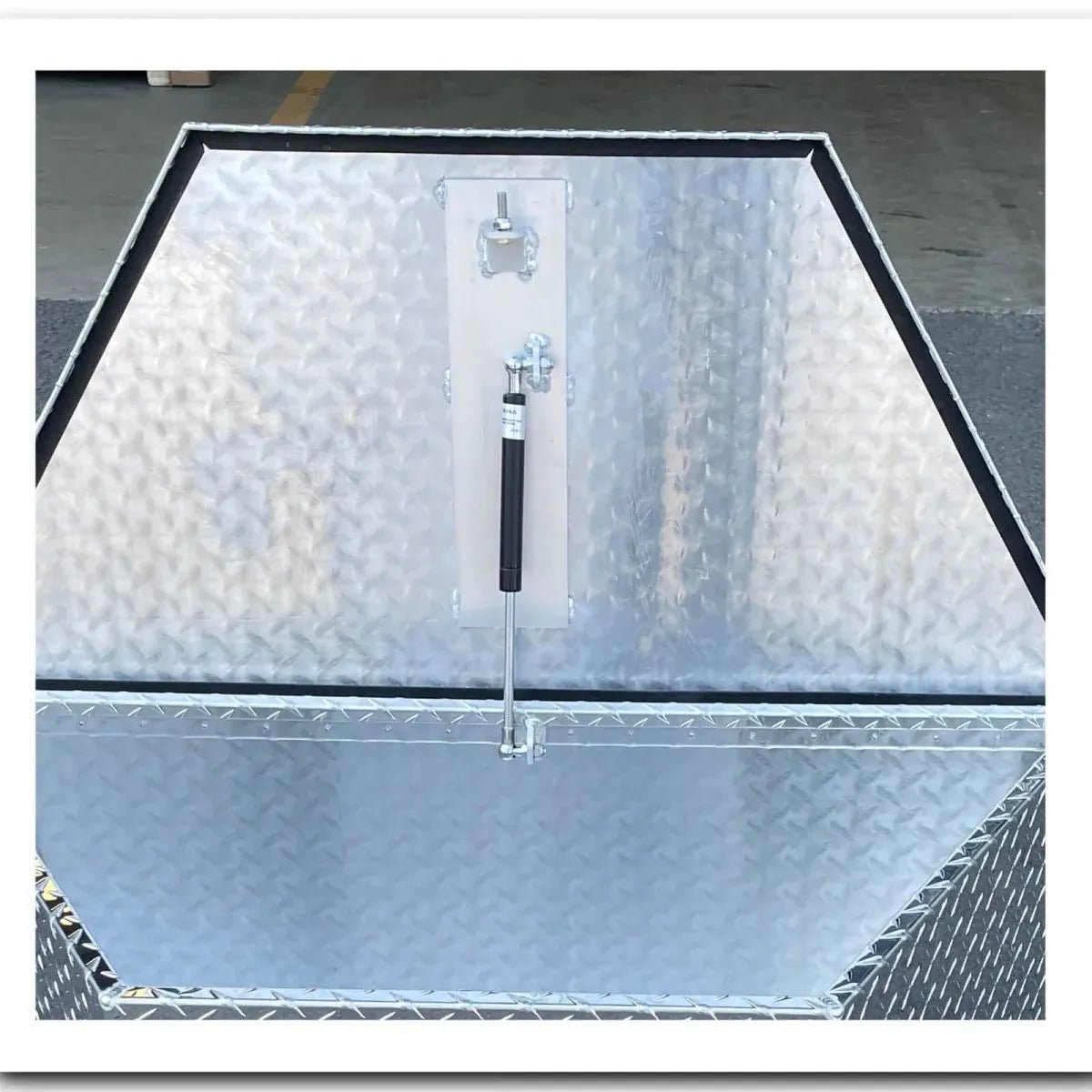 Front detail of aluminum trailer tongue tool box with locking lid and black rubber weather seal