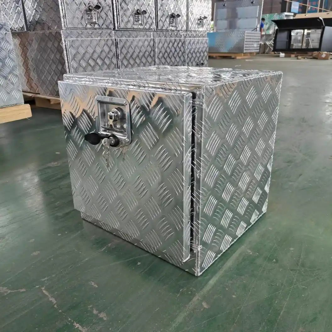 Heavy-duty aluminum underbody storage box in factory with lockable checker plate access door