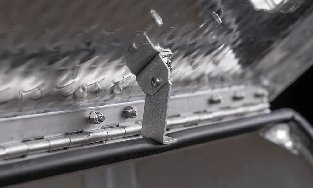 Close-up of the retaining bracket inside the 201031 aluminum step tool box lid