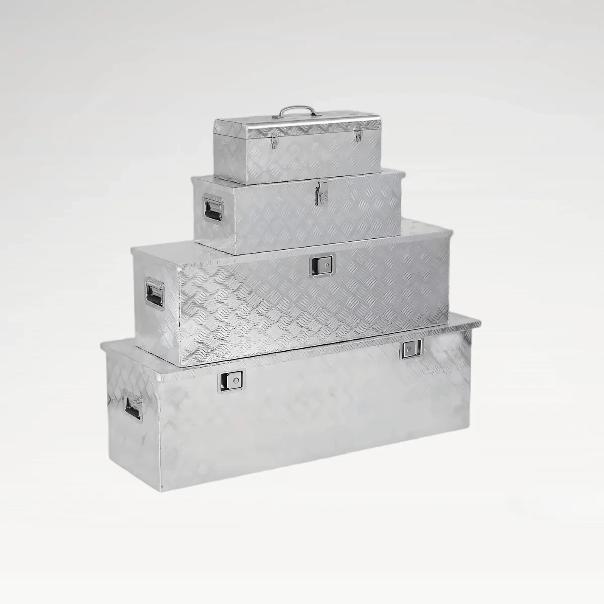 Four sizes of LANSHUO 201090-2 checker plate aluminum truck tool boxes stacked for comparison