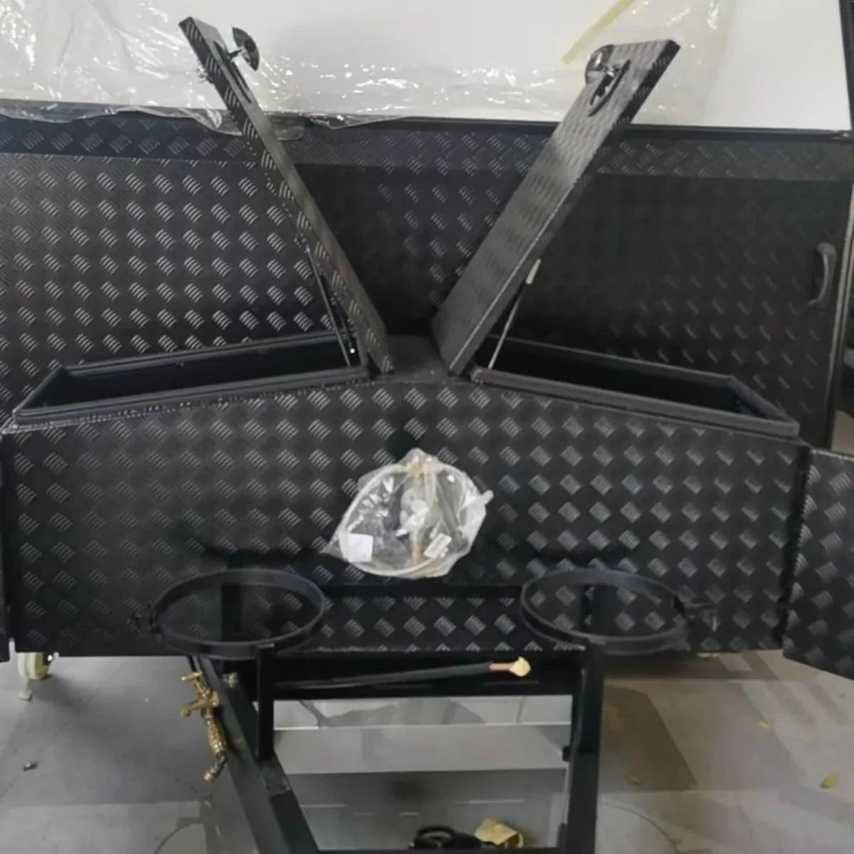 Top view of 201090 truck tool box installed around trailer equipment with divided access lids