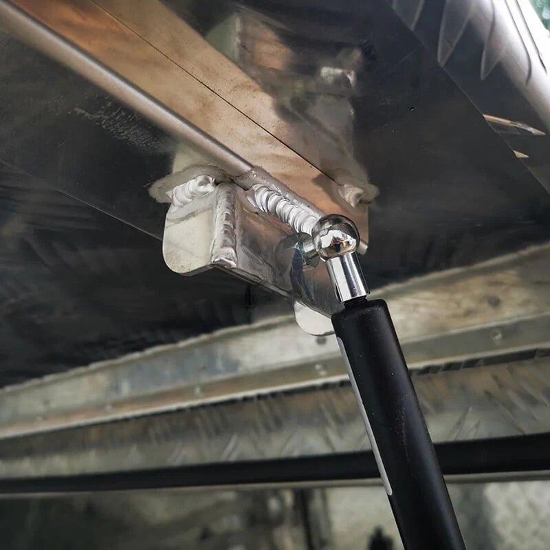 Close-up of gas strut mounting hardware inside the 201110 aluminum canopy tool box